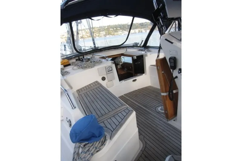 Slide: The Image of Interior view of a 2002 Nauticat 37 sailboat cockpit with wooden seating and nautical equipment. - 30