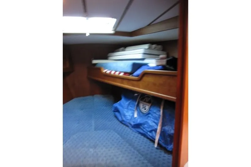 Slide: The Image of Cozy cabin interior of 2002 Nauticat 37 sailboat with storage and bedding. - 16