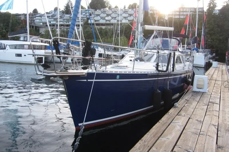 Slide: The Image of Nauticat 37 sailboat from 2002 docked at a marina, surrounded by other boats. - 40