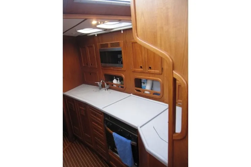 Slide: The Image of Wooden interior of 2002 Nauticat 37 yacht galley with modern appliances. - 14