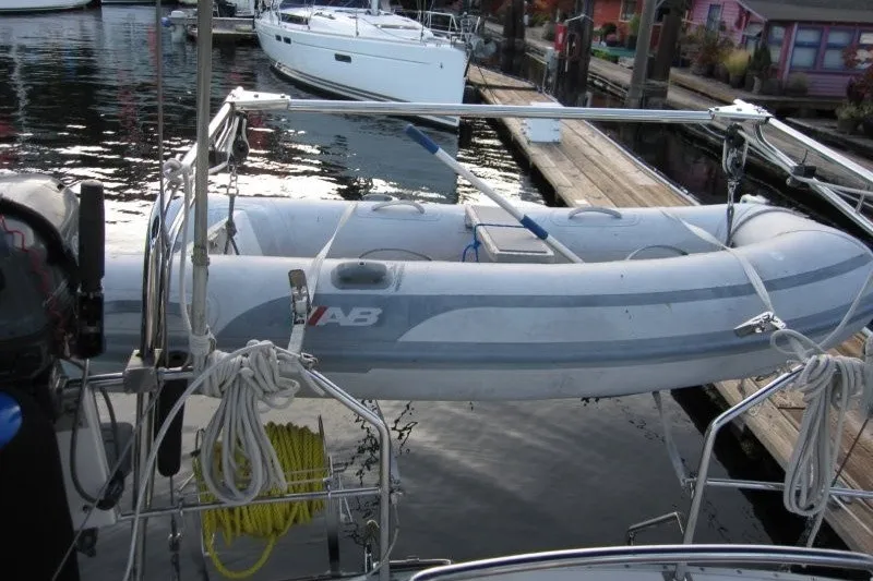Slide: The Image of Inflatable dinghy on a Nauticat 37 sailboat, docked in a marina, 2002 model. - 26