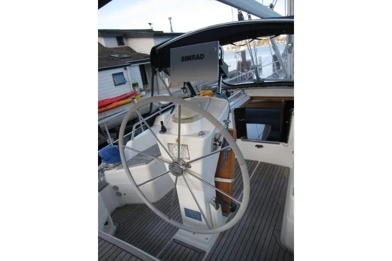 Slide: The Image of Steering wheel of a 2002 Nauticat 37 sailboat with Simrad navigation system. - 25
