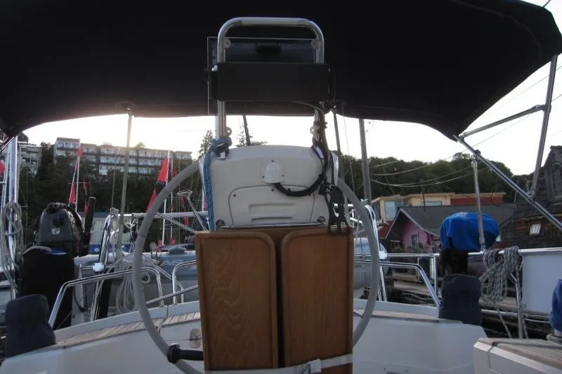 Slide: The Image of Cockpit of 2002 Nauticat 37 sailboat with steering wheel and canopy. - 24