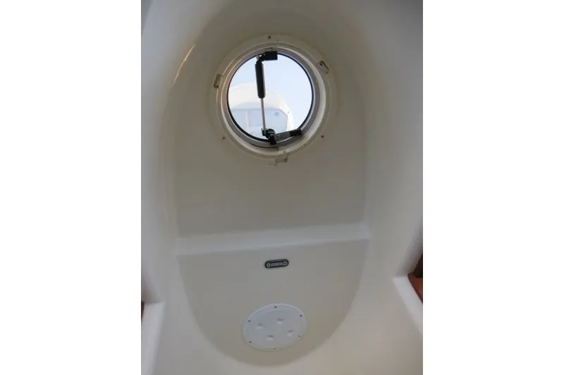 Slide: The Image of Porthole view inside 2002 American Tug 34 boat, showcasing interior design details. - 17