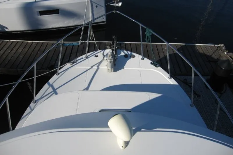 Slide: The Image of Bow view of a 2002 American Tug 34 docked at a marina. - 30