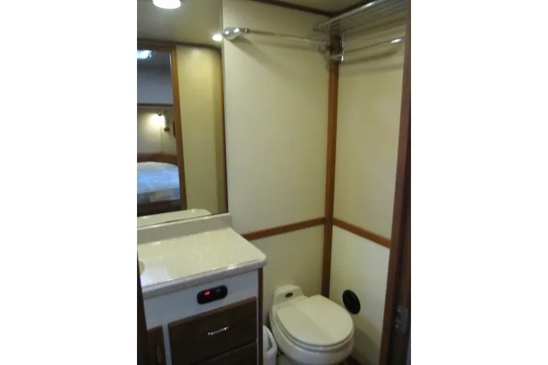 Slide: The Image of Bathroom interior of a 2002 American Tug 34 boat, featuring a compact design. - 14