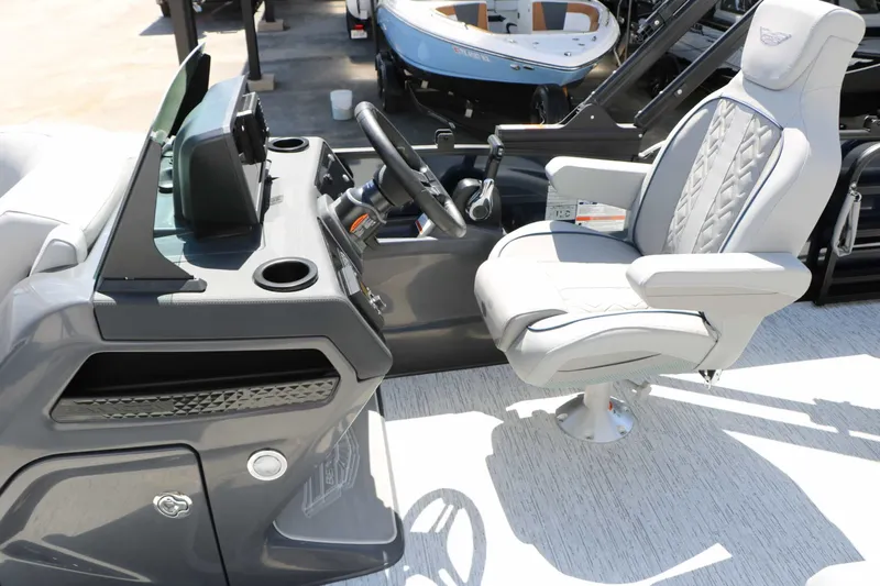 Slide: The Image of The image shows the cockpit of a Bennington 22 MSB Tri Toon with a sleek gray helm and cushioned captain's chair. - 42