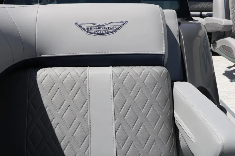 Slide: The Image of Gray, quilted upholstery with Bennington logo on a boat seat. - 35