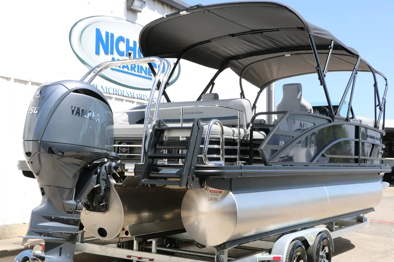 Slide: The Image of A 2027 Bennington 22 MSB Tri Toon with a Yamaha outboard motor, on a trailer. - 17