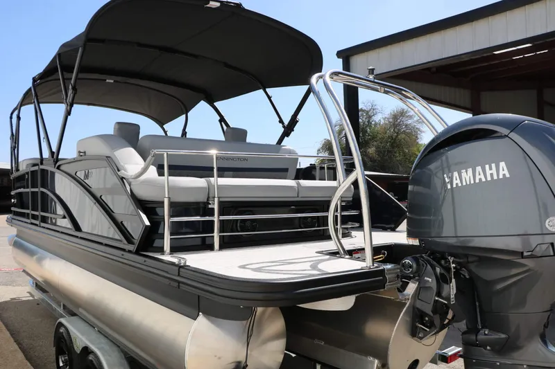 Slide: The Image of A 2027 Bennington 22 MSB Tri Toon with a Yamaha outboard motor, on a trailer. - 23