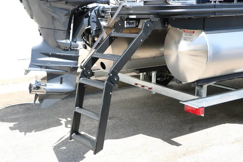 Slide: The Image of The 2027 Bennington 22 MSB Tri Toon features a sturdy swim ladder and a powerful outboard motor. - 20