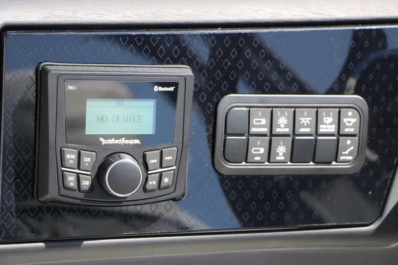 Slide: The Image of The image shows a control panel with a Rockford Fosgate Bluetooth device and several switches. - 47