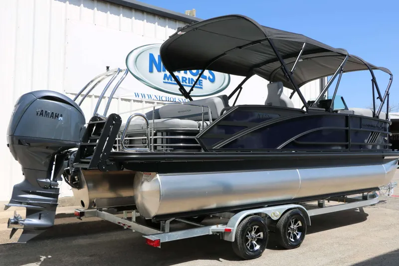 Slide: The Image of A 2027 Bennington 22 MSB Tri Toon on a trailer, featuring a Yamaha outboard motor. - 16