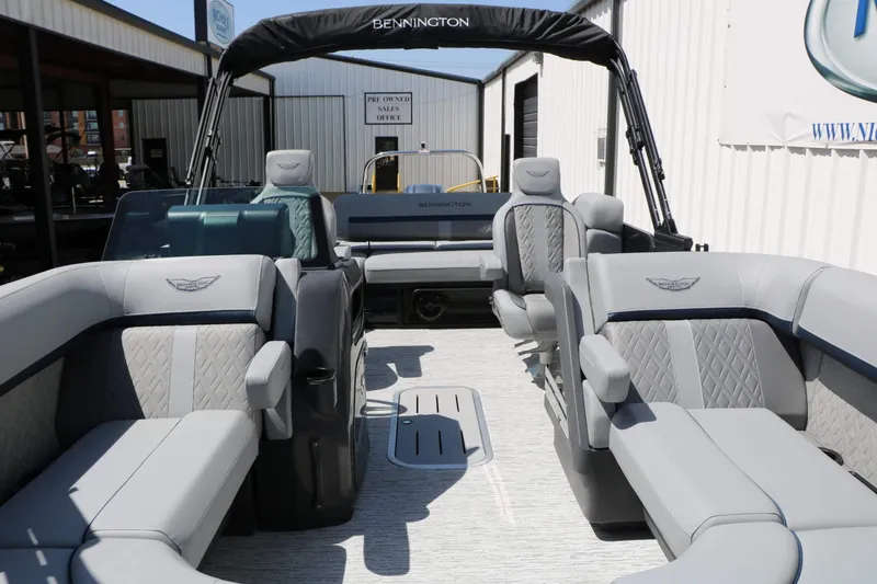 Slide: The Image of The image shows the interior of a 2027 Bennington 22 MSB Tri Toon with gray upholstery. - 29