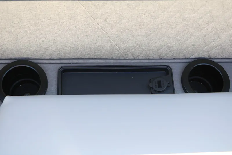 Slide: The Image of Close-up of a boat seat with two cup holders and a small storage area. - 34