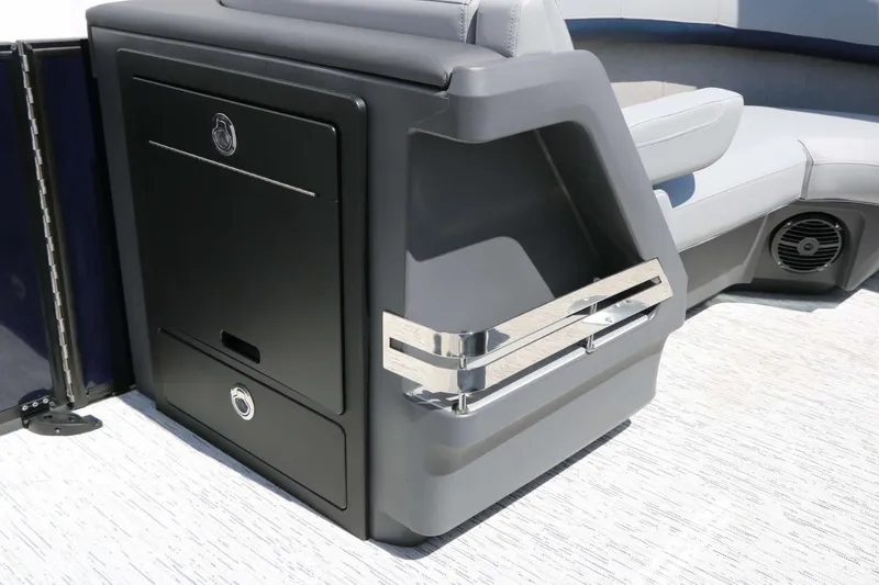 Slide: The Image of A modern boat with gray upholstery and a black storage compartment with silver handles. - 36