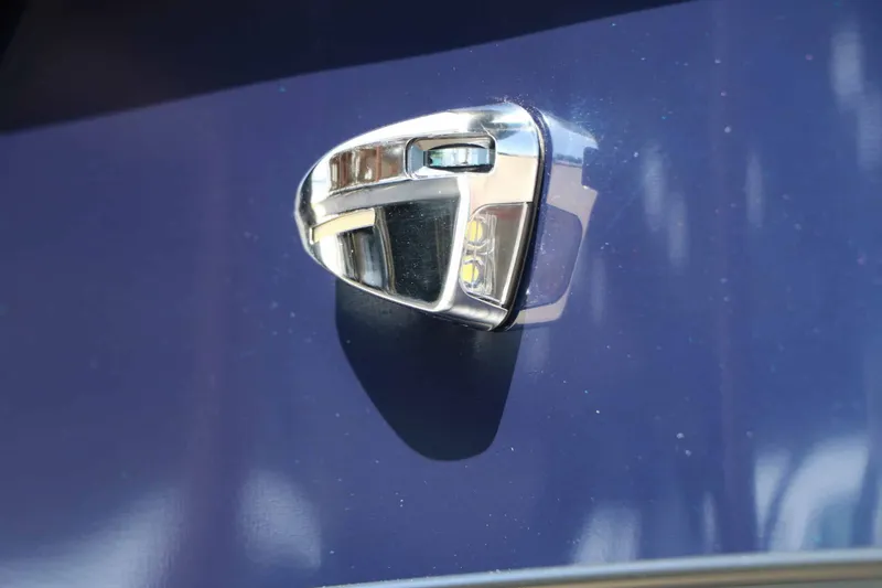 Slide: The Image of Close-up of a shiny, triangular metal handle on a blue surface. - 14