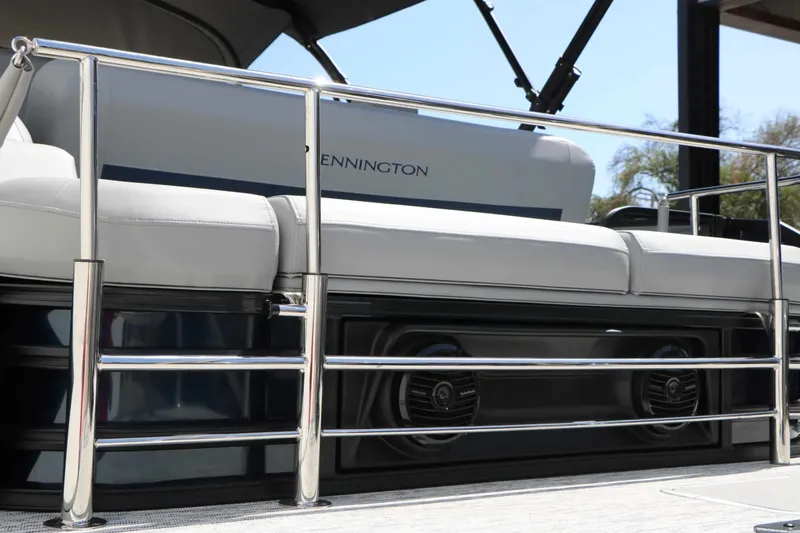 Slide: The Image of The image shows the rear of a Bennington 22 MSB Tri Toon with sleek metal railings and comfortable seating cushions. - 24