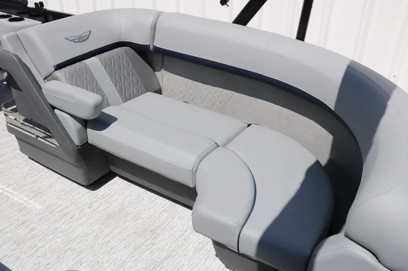 Slide: The Image of Gray upholstered seating on a boat with quilted pattern and armrest. - 30