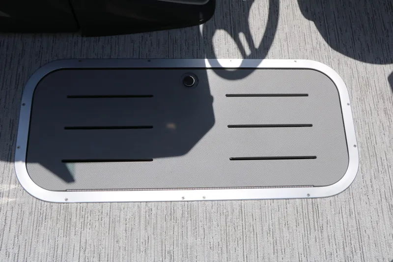Slide: The Image of A gray flooring with a rectangular slotted insert and a small round handle. - 39