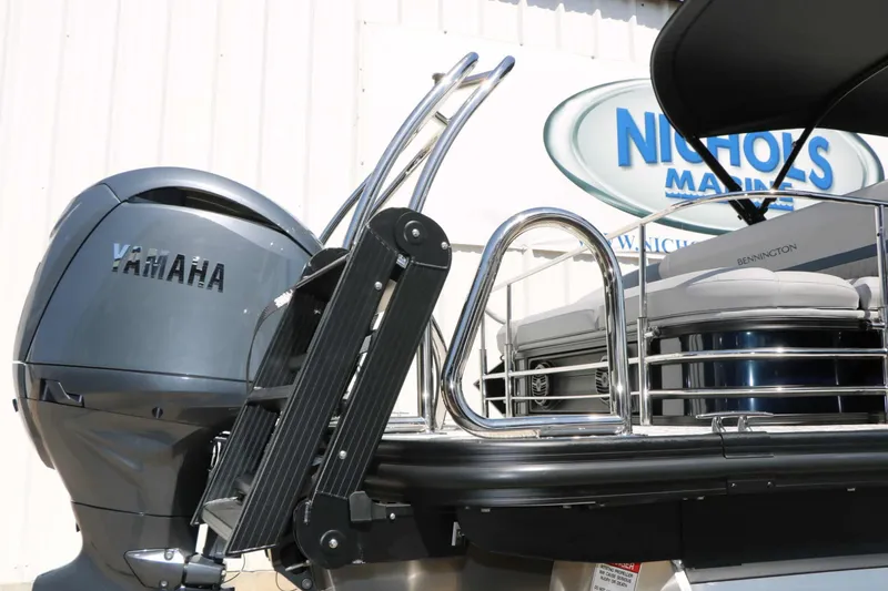 Slide: The Image of A 2027 Bennington 22 MSB Tri Toon with a Yamaha outboard motor and a swim ladder. - 25