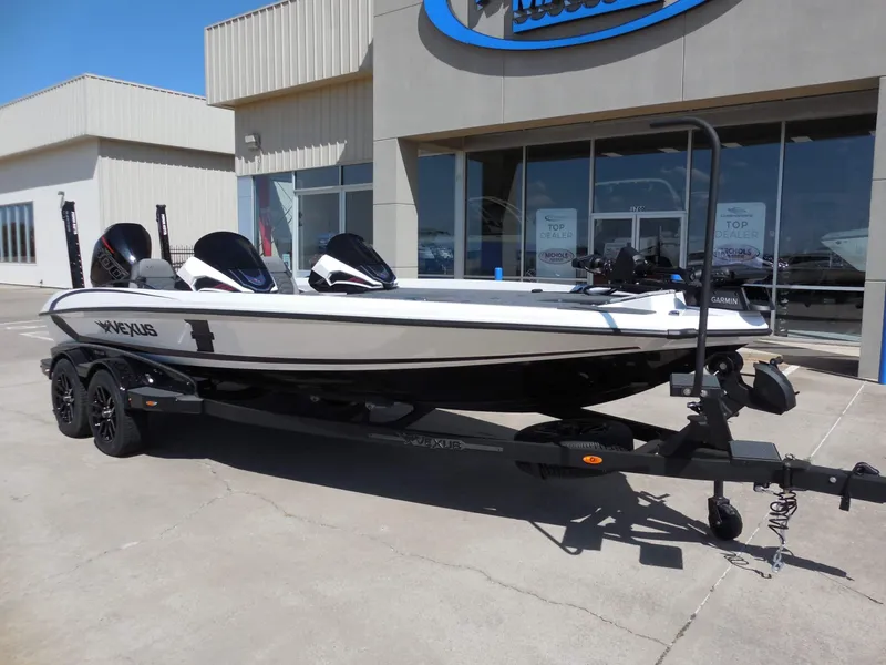 Slide: The Image of A 2027 Vexus VXs21 boat on a trailer in front of a building. - 2