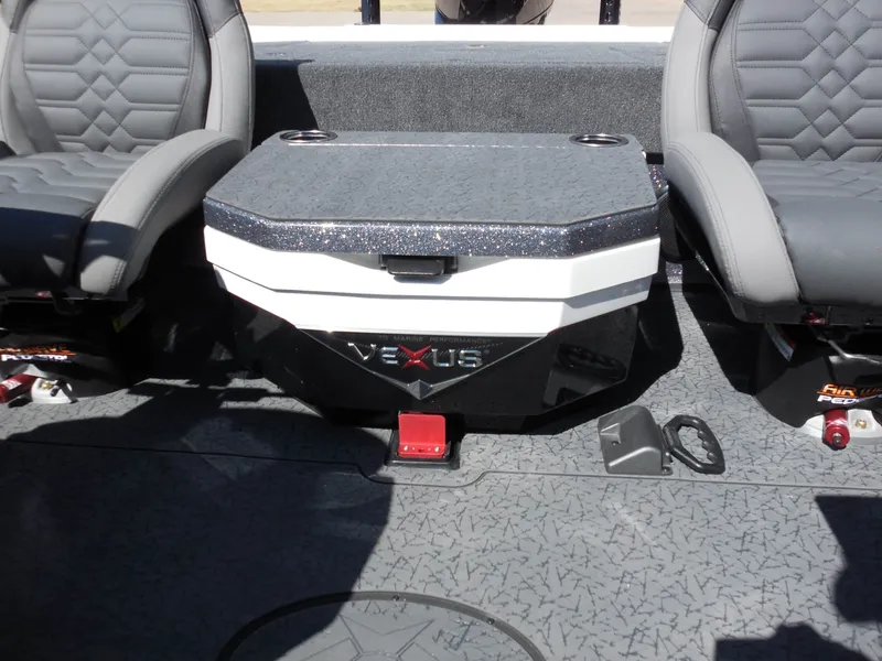 Slide: The Image of The image shows the interior of a Vexus VXs21 boat with two gray seats and a central storage area. - 20
