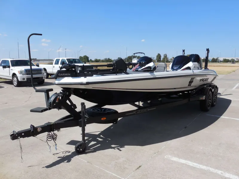 Slide: The Image of A 2027 Vexus VXs21 boat on a trailer, parked on a concrete lot. - 7
