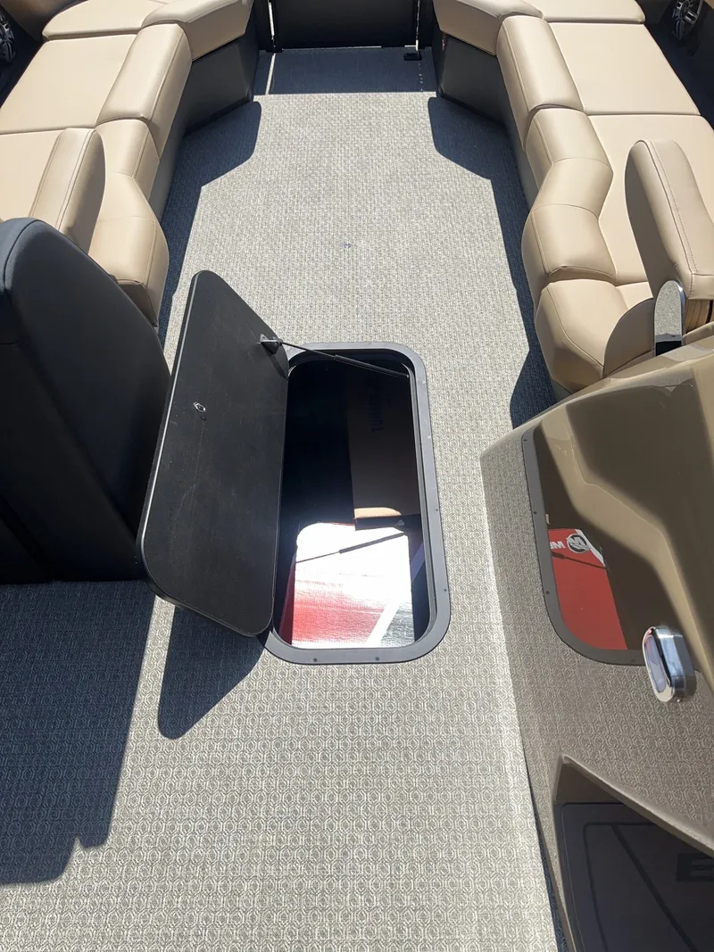 Slide: The Image of The image shows the interior of a 2027 Evotti 525 CS boat with beige seating and an open storage compartment. - 8