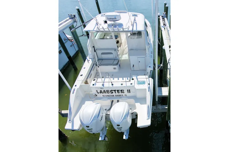 Slide: The Image of 2023 Pusuit d 326 boat docked with twin engines, aerial view. - 3