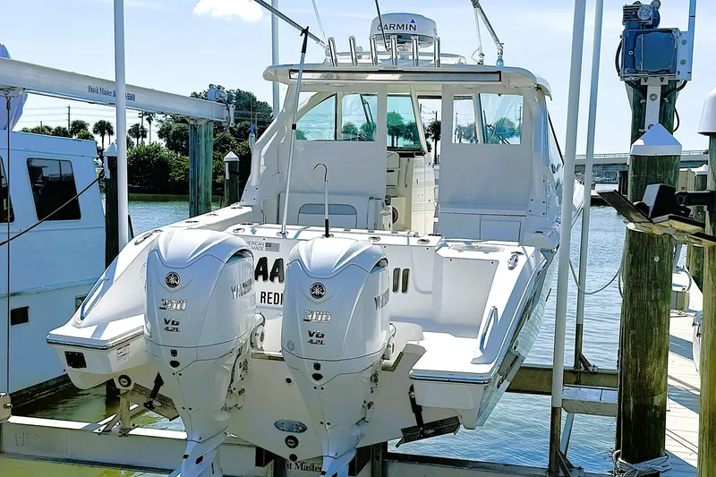 Slide: The Image of 2023 Pusuit d 326 boat with twin Yamaha V6 engines docked by the water. - 19