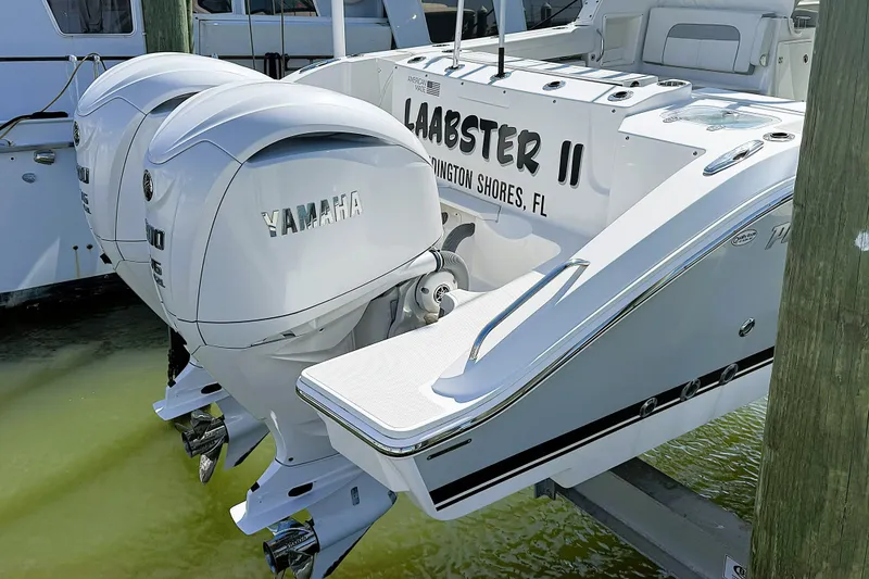 Slide: The Image of Twin Yamaha engines on a 2023 Pursuit D 326 boat docked in Wilmington Shores. - 20