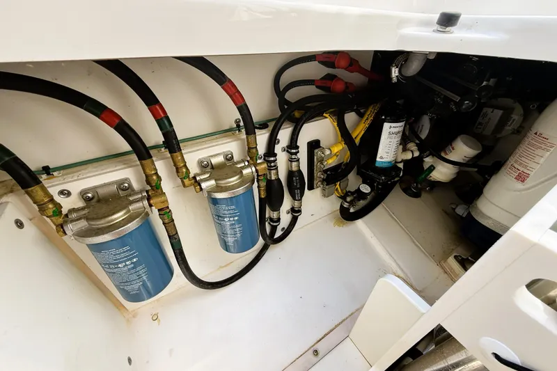 Slide: The Image of Engine compartment of 2023 Pusuit d 326 boat with fuel filters and hoses. - 21