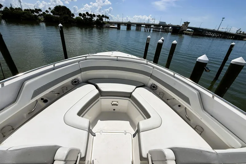 Slide: The Image of Bow seating area of 2023 Pusuit d 326 boat, docked by a scenic waterfront. - 16
