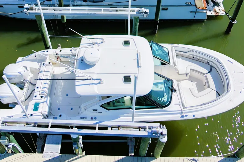 Slide: The Image of Aerial view of 2023 Pusuit d 326 boat docked in marina. - 0