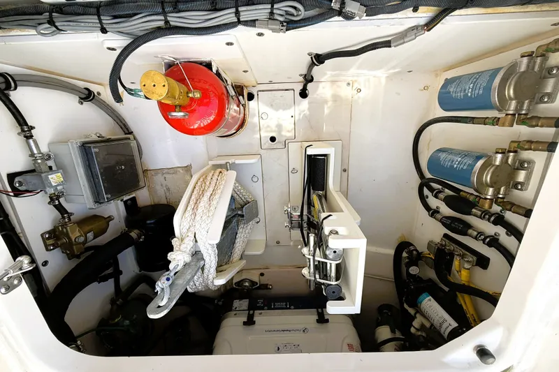 Slide: The Image of Engine compartment of 2023 Pusuit d 326 boat with fire extinguisher and mechanical components. - 23