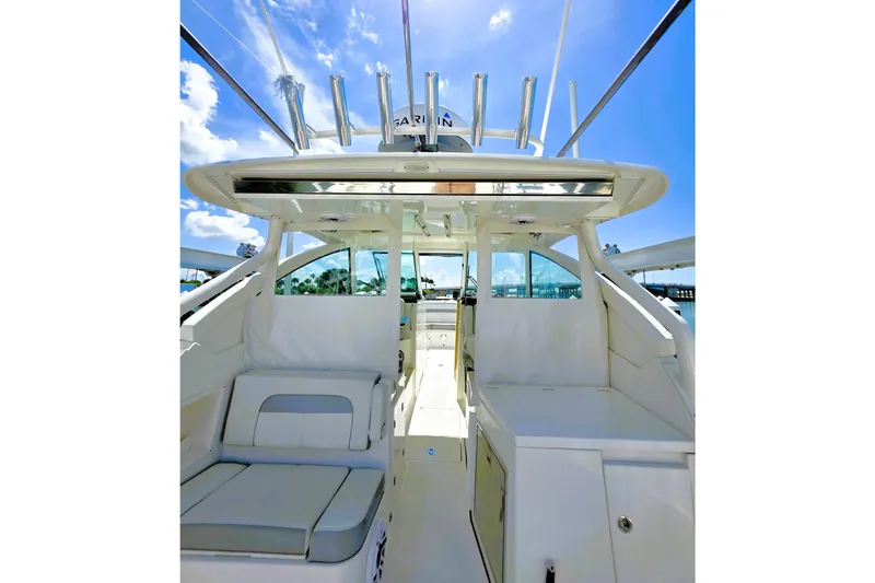 Slide: The Image of Interior view of 2023 Pusuit d 326 boat, featuring seating and rod holders under a clear sky. - 6