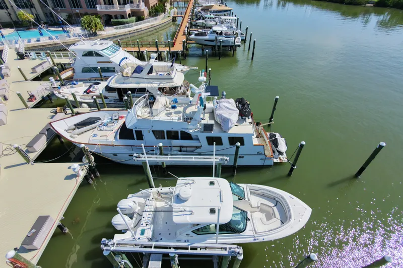 Slide: The Image of Boats docked at a marina, featuring a 2023 Pursuit DC 326 in the foreground. - 25