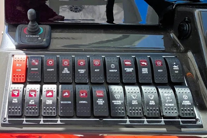 Slide: The Image of Control panel of a 2023 Pusuit d 326 boat with labeled switches. - 12