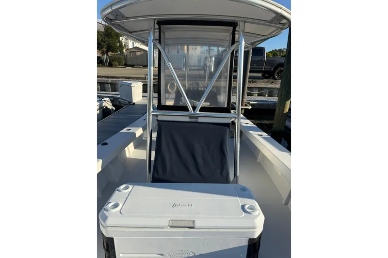 Slide: The Image of 2015 C-Hawk 25 Center Console boat with cooler and seating, docked at marina. - 16