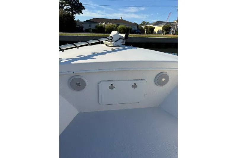 Slide: The Image of 2015 C-Hawk 25 Center Console boat deck with speakers and storage compartment. - 15