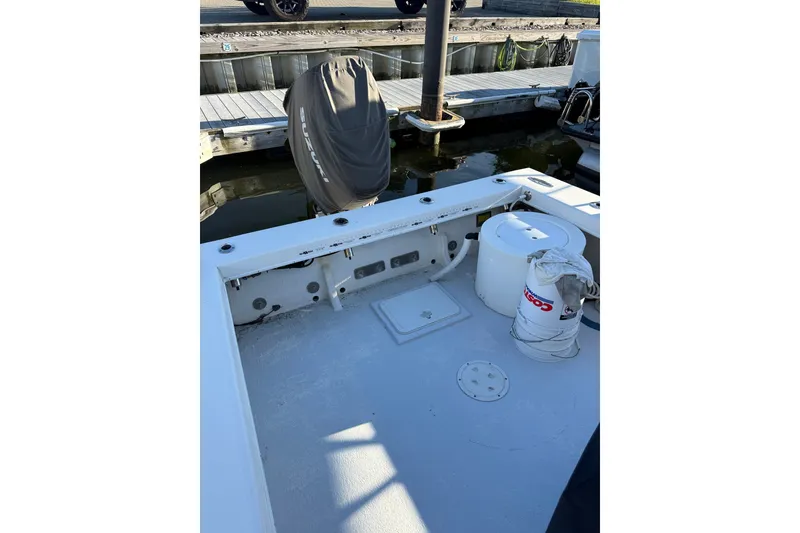 Slide: The Image of 2015 C-Hawk 25 Center Console boat docked, featuring a covered Suzuki outboard motor. - 4