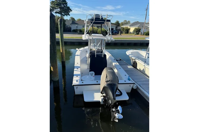 Slide: The Image of 2015 C-Hawk 25 Center Console boat docked, featuring an outboard motor and elevated helm. - 0