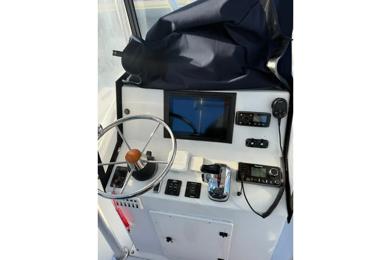 Slide: The Image of Center console of 2015 C-Hawk 25, featuring steering wheel and navigation equipment. - 5