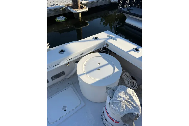 Slide: The Image of 2015 C-Hawk 25 Center Console boat interior with storage and dock view. - 18