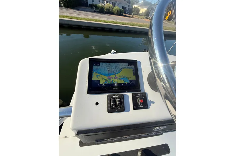 Slide: The Image of 2015 C-Hawk 25 Center Console boat with navigation display and controls. - 9