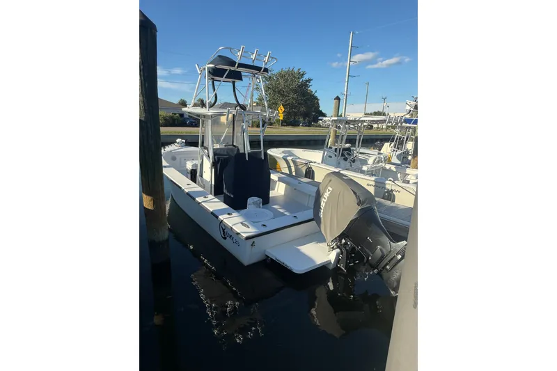 The Image of 2015 C-Hawk 25 Center Console boat docked with Suzuki outboard motor. - 1
