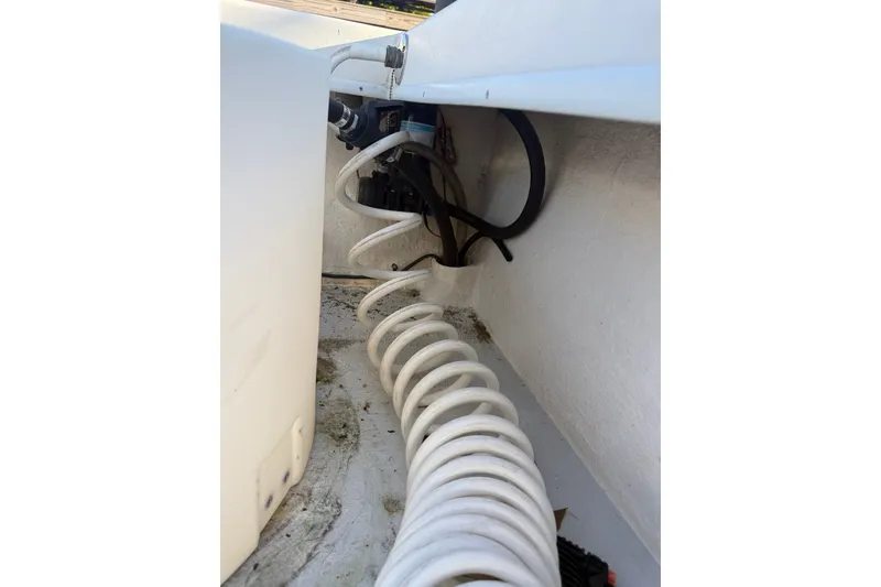 Slide: The Image of Interior view of 2015 C-Hawk 25 Center Console boat showing coiled hose and wiring. - 22