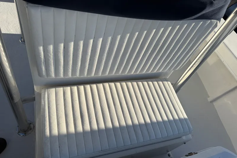 Slide: The Image of White cushioned seating on a 2015 C-Hawk 25 Center Console boat. - 17