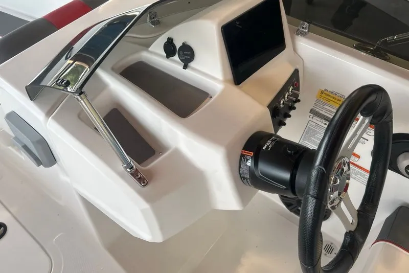 Slide: The Image of 2027 Tahoe T18 boat dashboard with steering wheel and control panel. - 8